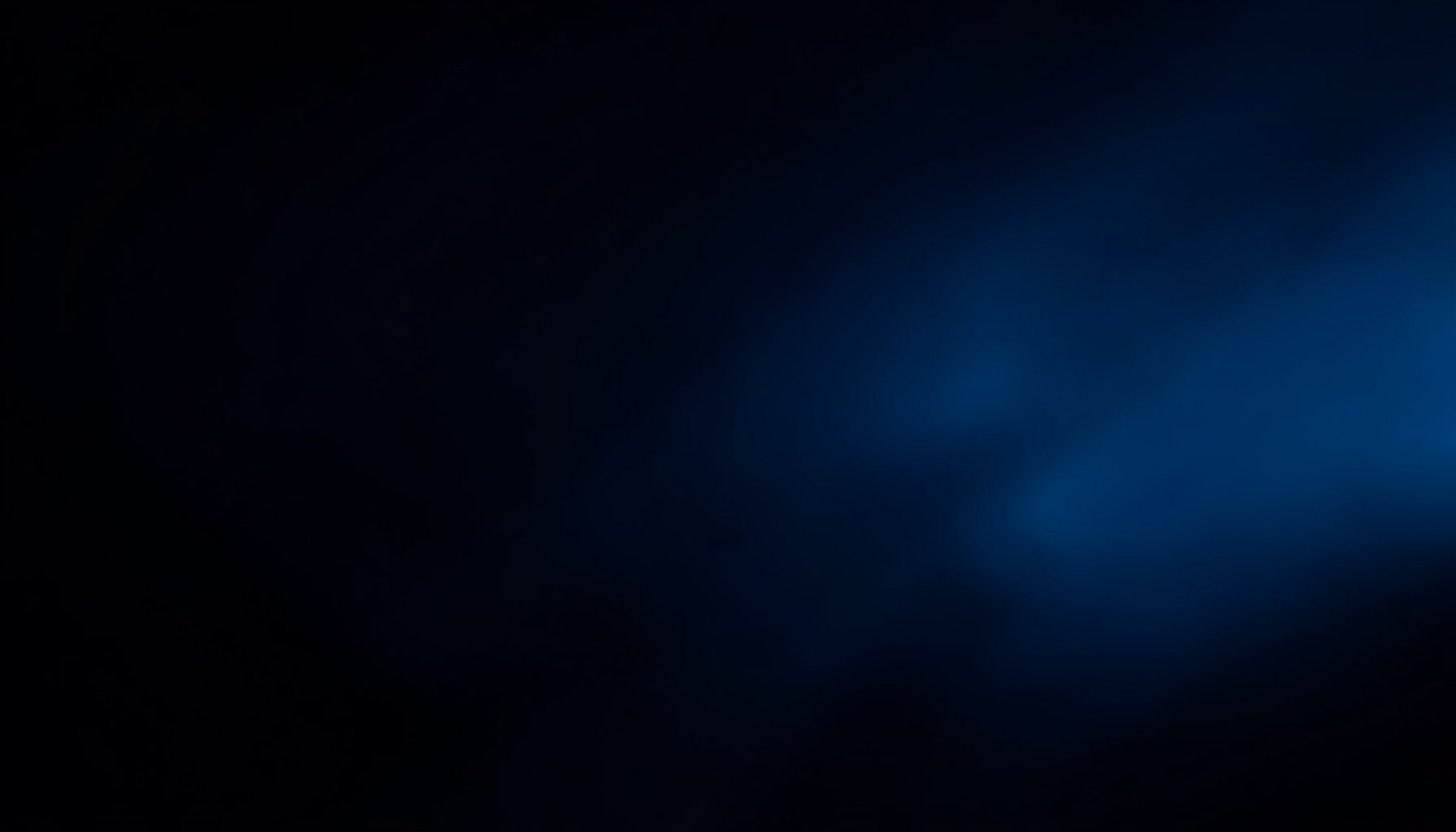 Dark navy and deep blue abstract background with soft glowing highlights, conveying a calm and professional nighttime atmosphere